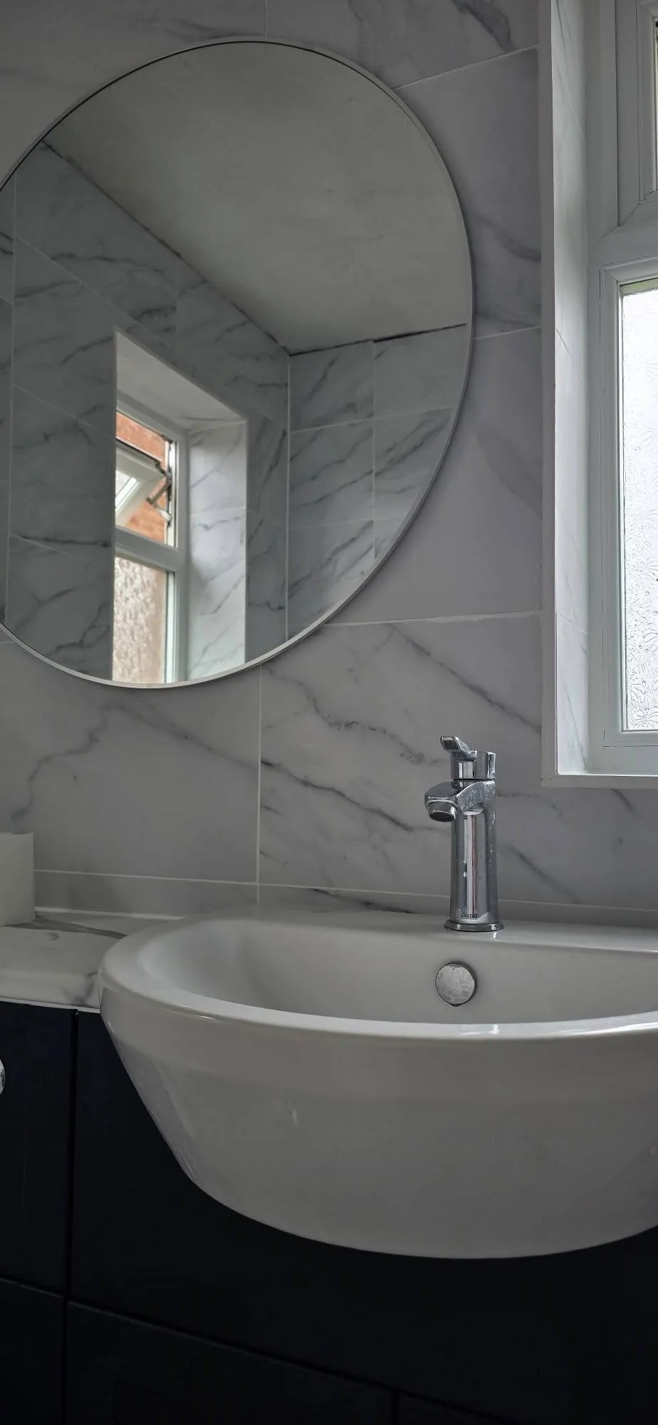 Marble Bathroom with Round Mirror